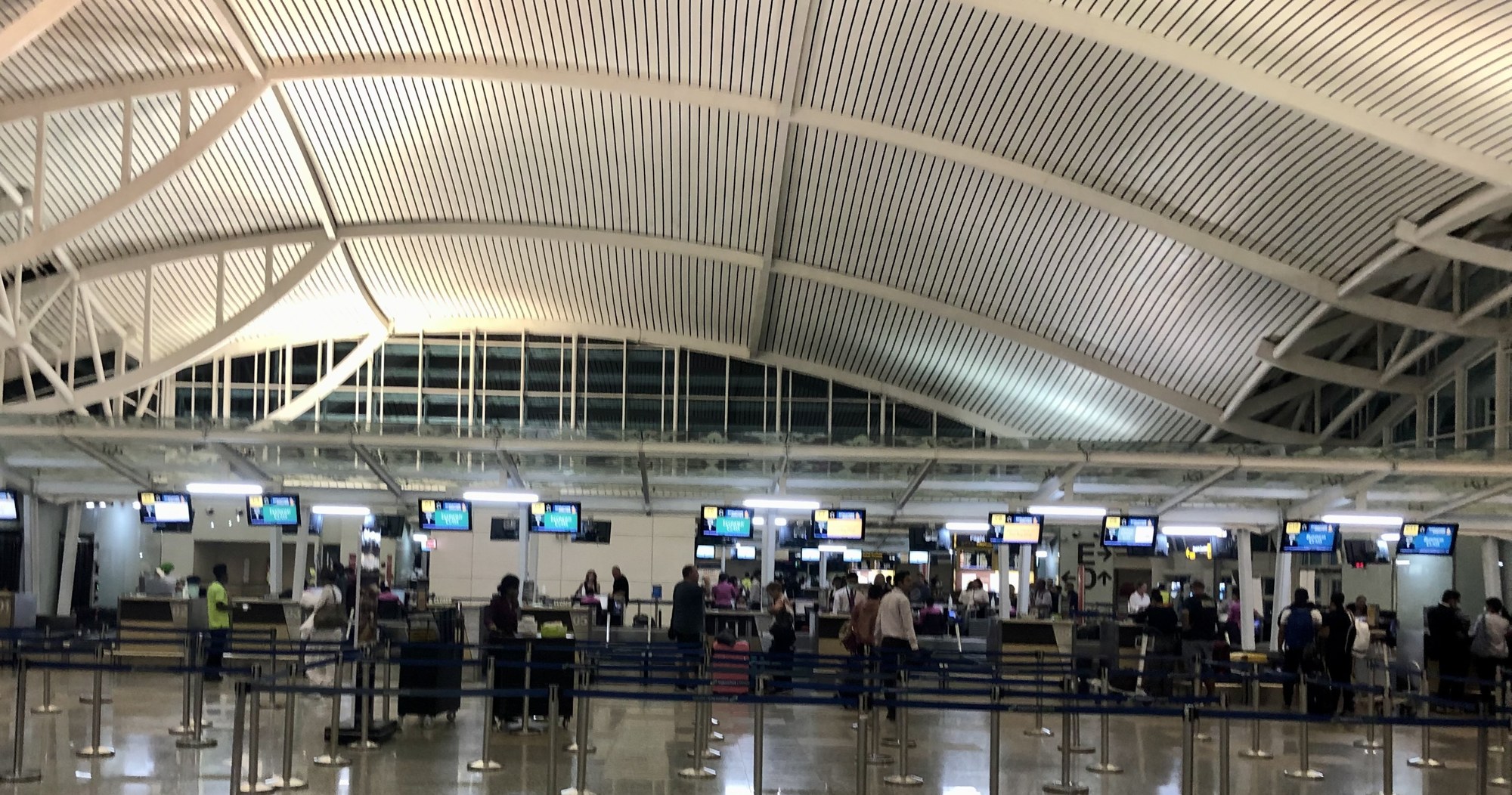 Queue lanes and service counters in the international terminal hall of Bali's I Gusti Ngurah Rai International Airport