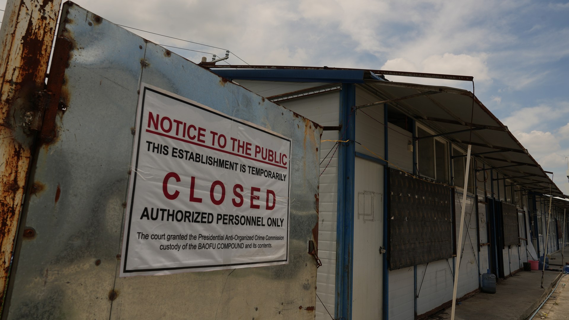 Closure notice posted on the gate of the Baofu compound in Bamban, Philippines, after authorities took custody of the site